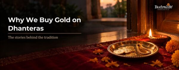 Why we buy gold on Dhanteras: gold coins & a gold chain on a brass plate beside a diya & marigolds