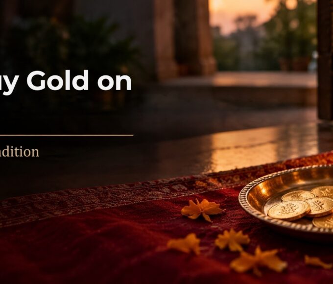 Why we buy gold on Dhanteras: gold coins & a gold chain on a brass plate beside a diya & marigolds