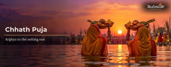 Chhath Puja 2026 devotees offering Sandhya Arghya with bamboo soop trays to the setting sun in a river