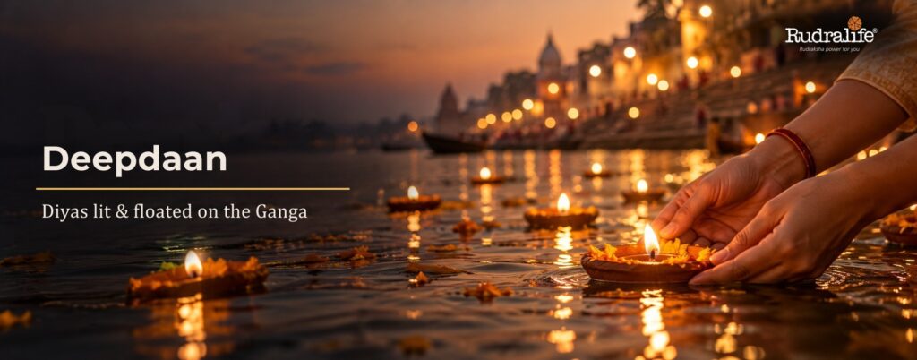 Dev Diwali 2026 deepdaan, a devotee floating a lit diya on the Ganga at the ghats of Varanasi